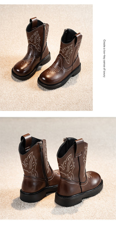 Girls' brown Martin boots with white ethnic embroidery, side zippers, and black soles, displayed on a light carpet. - Image 9