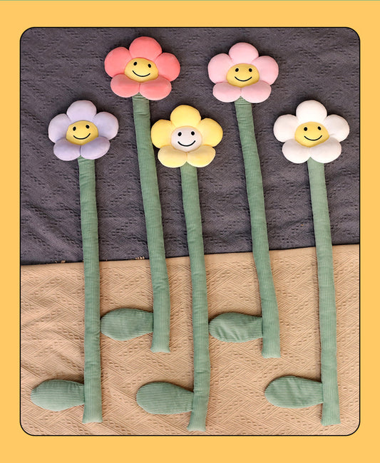 Plush white sunflower curtain buckle with a yellow smiley face center and green stem, holding back a dark green curtain.