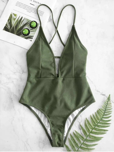 Olive green ribbed one-piece swimsuit with deep V-neck and criss-cross back straps, laid flat on marble. - Image 7