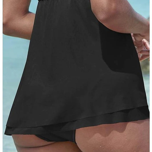 Woman in a brown strapless ruched one-piece swimdress with a flowing skirt, standing in shallow ocean water. - Image 2