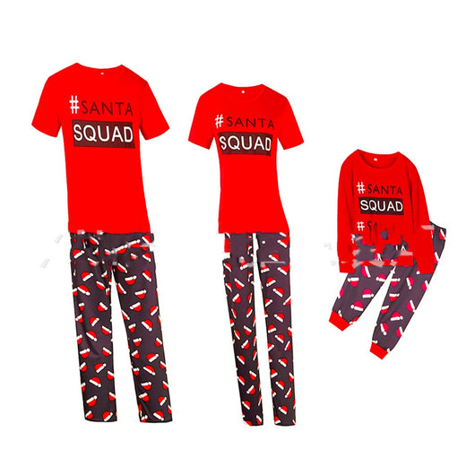 Matching family Christmas pajamas with red long-sleeve tops reading "#SANTA SQUAD" and black pants with a red Santa hat pattern. - Image 3