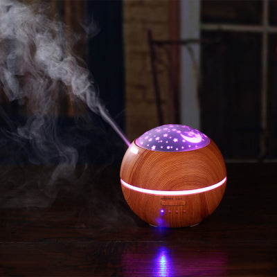 Mini wood grain aroma diffuser and humidifier with a starry night light projector, emitting mist and glowing purple. - Image 4