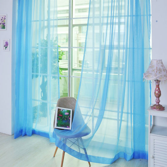 Pair of sheer blue polyester curtains for light transmission, ready-made and punch-free, hanging in a window. - Image 2