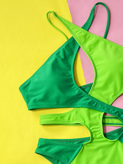 Women's hollow contrast color one-piece swimsuit in vibrant green and lime green with a halter neck and cut-outs. - Image 4