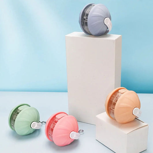 Light blue and white automatic rolling cat toy ball with a purple faux tail, featuring a power button. - Image 25