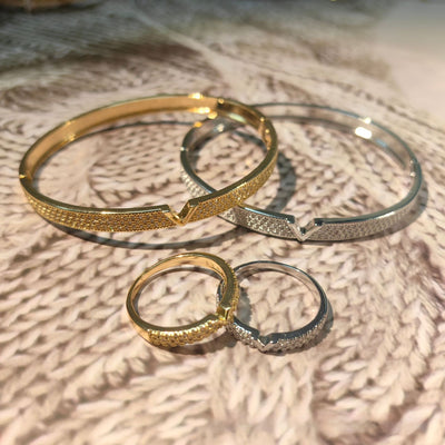 V-shaped 18K gold electroplated bracelet and ring set with pave clear stones on a white stand. - Image 11