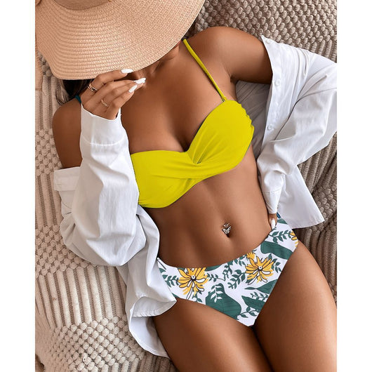 Teal twisted bandeau bikini top with tropical leaf print high-waisted bottoms on a model wearing a white shirt. - Image 8