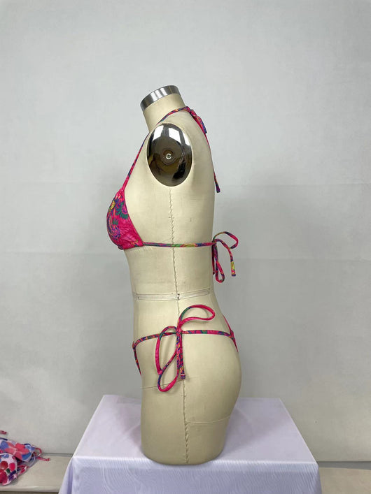 Women's pink paisley print bikini set with halter top featuring a cutout and tie-side thong bottoms. - Image 10