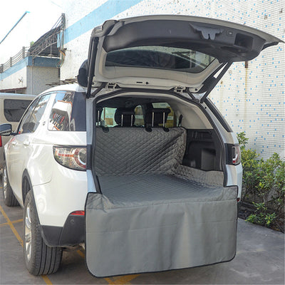 Gray quilted pet car mat installed in the trunk of a white SUV, protecting the cargo area and bumper. - Image 8