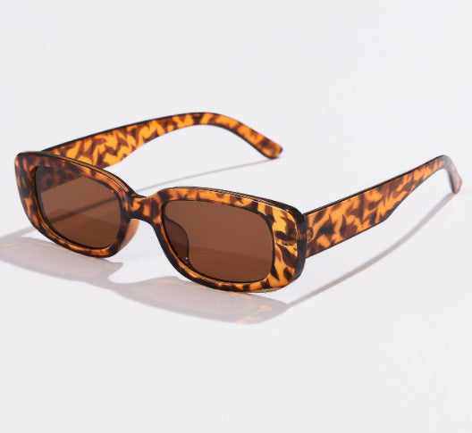 Rectangular tortoiseshell sunglasses with a small frame and dark gray lenses, angled on a white background. - Image 8