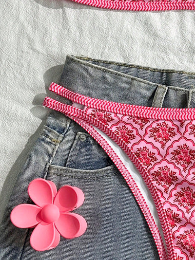Pink two-piece bikini with a red floral and geometric print, featuring a bandeau top and high-cut bottoms. - Image 5
