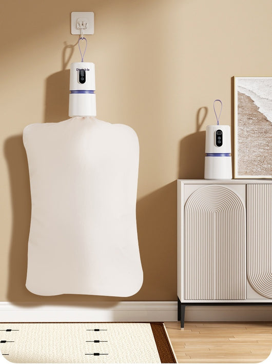 White and blue mini household air dryer with a digital display and hanging loop, shown next to a gold smartphone. - Image 19