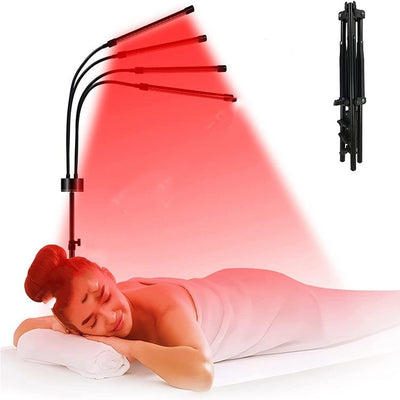 Red light therapy lamp with four adjustable arms illuminating a person lying on a white massage table. - Image 5