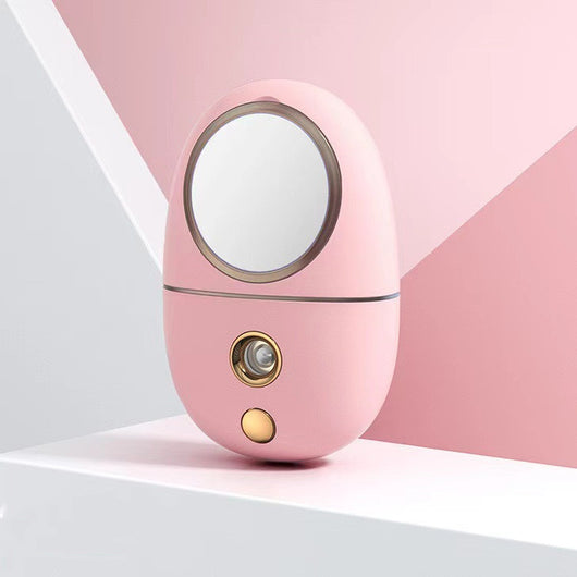 White egg-shaped portable facial humidifier with a pink cartoon rabbit inside a clear dome, gold nozzle and button. - Image 7