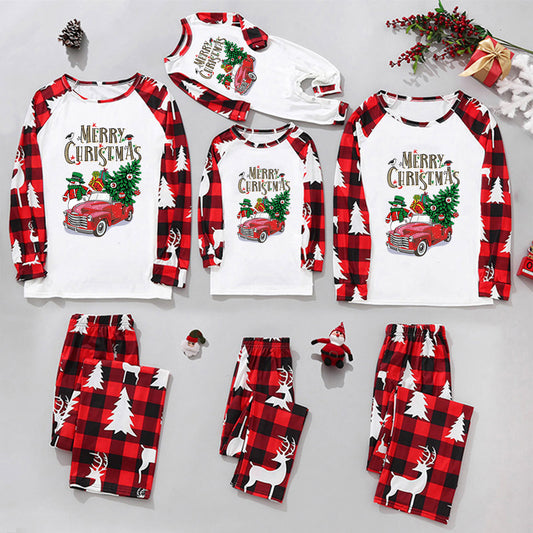 Matching family Christmas pajamas in red and black buffalo plaid with a vintage car, snowman, and 'Merry Christmas' graphic.
