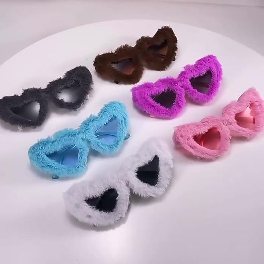 Pink plush heart-shaped sunglasses with light pink tinted lenses and matching pink plastic temples.