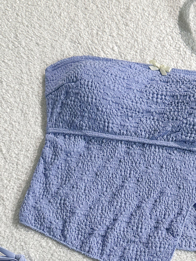 Light blue textured two-piece bikini with a strapless top and high-cut bottom with side ties and white bows. - Image 9