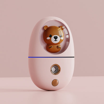 White egg-shaped portable facial humidifier with a pink cartoon rabbit inside a clear dome, gold nozzle and button. - Image 17