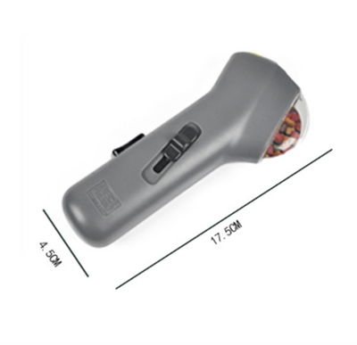 Dog Treat Launcher in retail packaging, a gray handheld device for dispensing snacks during training or playtime. - Image 15