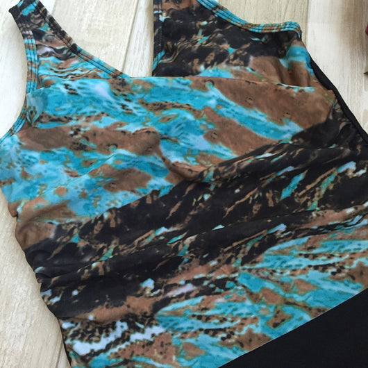 Women's one-piece swimsuit with a black bottom and a blue, brown, and white abstract patterned, ruched V-neck top. - Image 8
