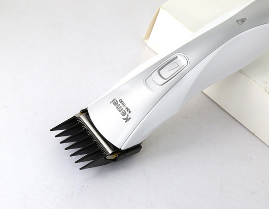 White and silver Kemei KM-1830 electric hair clipper with a charging base on a light background. - Image 5