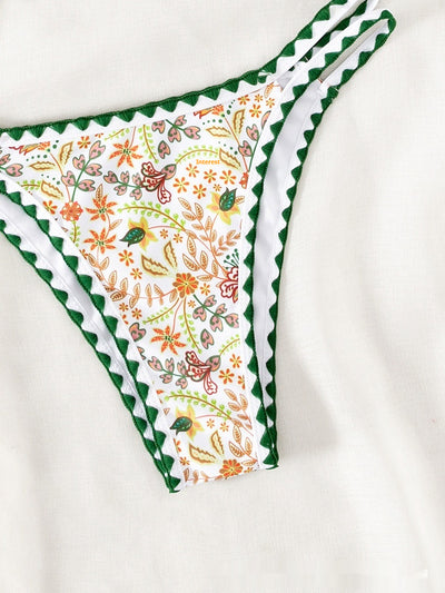 White halter bikini with green rickrack trim and a vibrant floral and bird print, featuring a triangle top and high-cut bottom. - Image 11