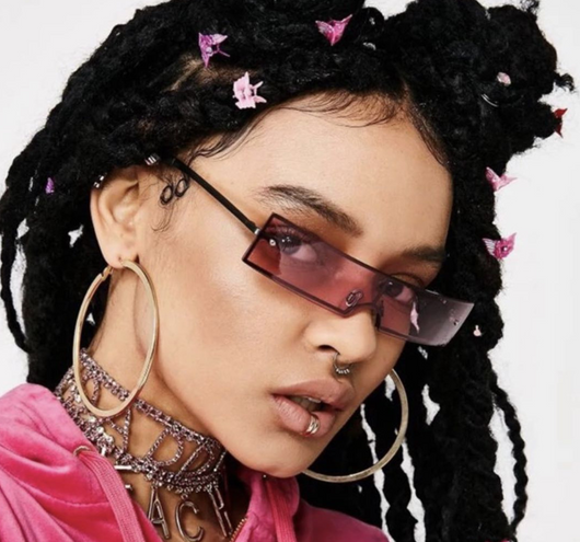 Red rectangular rimless sunglasses with gold-colored metal temples and black ear tips on a white background.