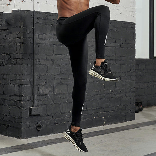 Black men's fitness pants with a tight fit, elastic waistband, and reflective strips on the lower legs. - Image 4