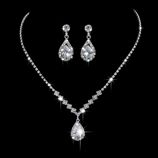 Sparkling rhinestone necklace and matching teardrop earrings set, ideal for bridal or formal occasions.