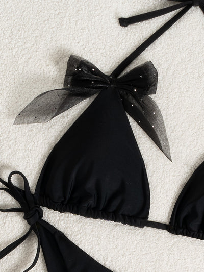 Black strappy backless bikini two-piece swimsuit for women with triangle top and tie-side bottoms, featuring sheer polka dot bows. - Image 13