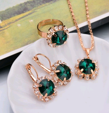 Rose gold-toned necklace, earrings, and ring set with large oval clear gemstones surrounded by smaller stones. - Image 22