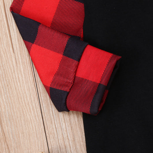 Family matching Christmas pajamas with black tops, red plaid sleeves, and Santa wearing a mask, paired with red plaid pants. - Image 11