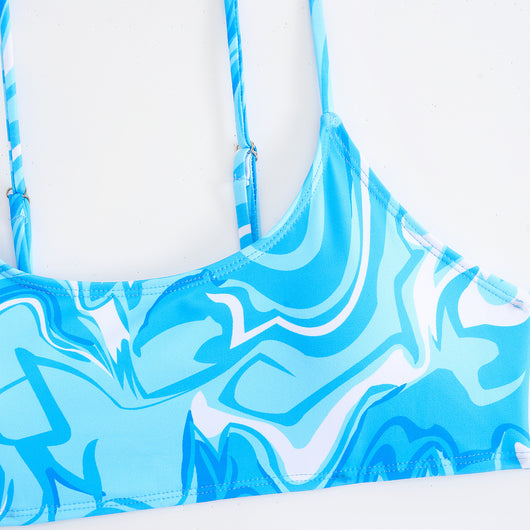 Red, orange, and white abstract swirl print three-piece bikini set with matching shorts, shown with a straw hat and sunglasses. - Image 17