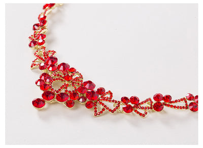 Red rhinestone bridal jewelry set featuring a floral necklace and matching dangle earrings on a model. - Image 3
