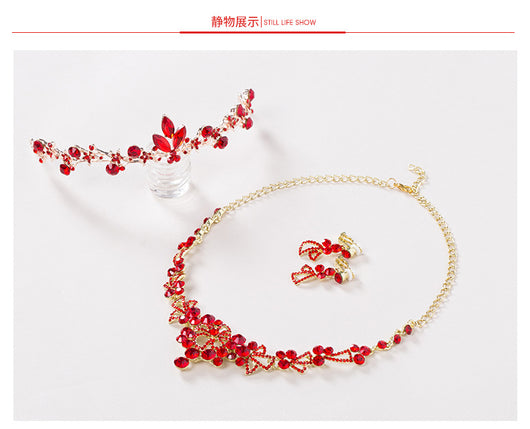 Red rhinestone bridal jewelry set featuring a floral necklace and matching dangle earrings on a model. - Image 7