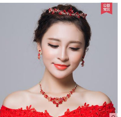 Red rhinestone bridal jewelry set featuring a floral necklace and matching dangle earrings on a model. - Image 5