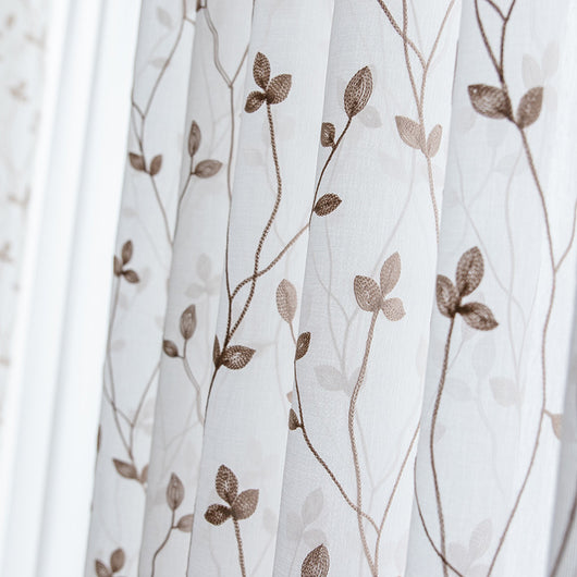 Sheer white curtains with a delicate brown leafy vine pattern, offering light transmission for a pastoral style room.