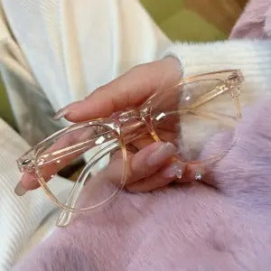 Retro square transparent full-frame glasses with blue light lenses, held by a person wearing grey sweatpants. - Image 15