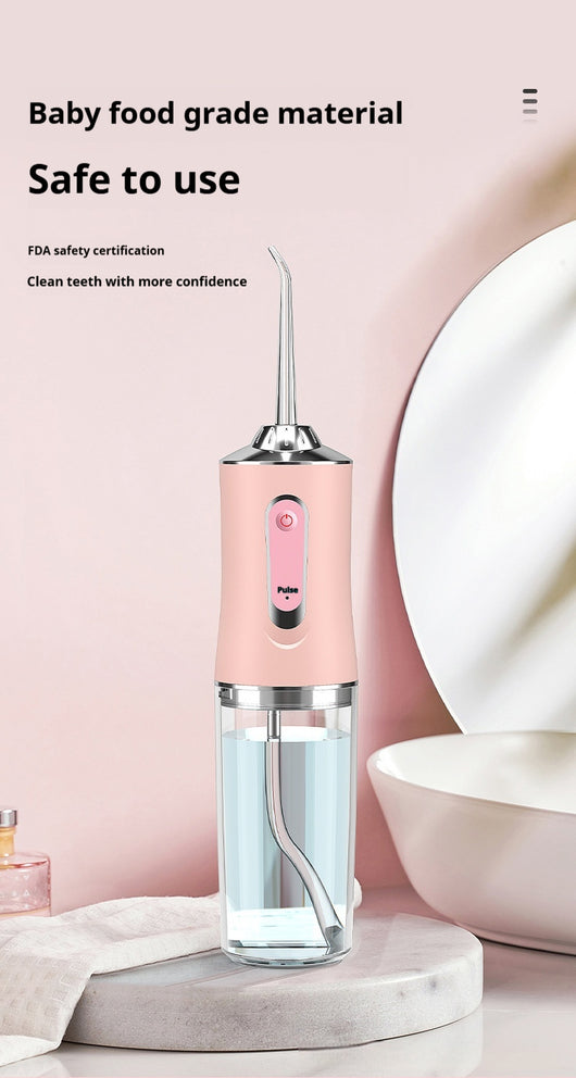 Pink portable electric oral irrigator with clear water tank and four nozzles, highlighting adjustable pressure and pulse mode. - Image 10