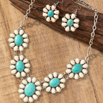 Vintage-style silver-tone necklace and dangle earrings set with oval frames and marbled blue and yellow stones.