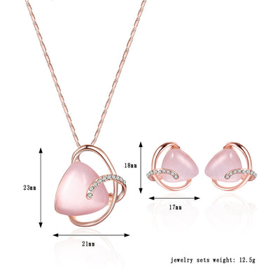 Rose gold-toned necklace and stud earrings set with triangular pink stones and clear rhinestone accents. - Image 8