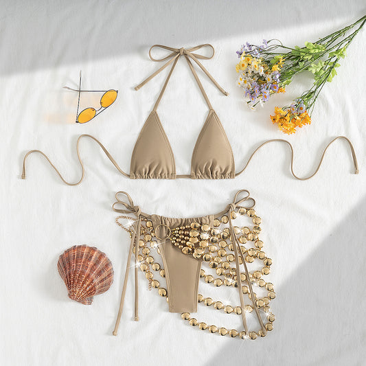 Copper halter bikini top and bottom with a gold beaded skirt, laid flat with sunglasses, seashell, and flowers. - Image 2