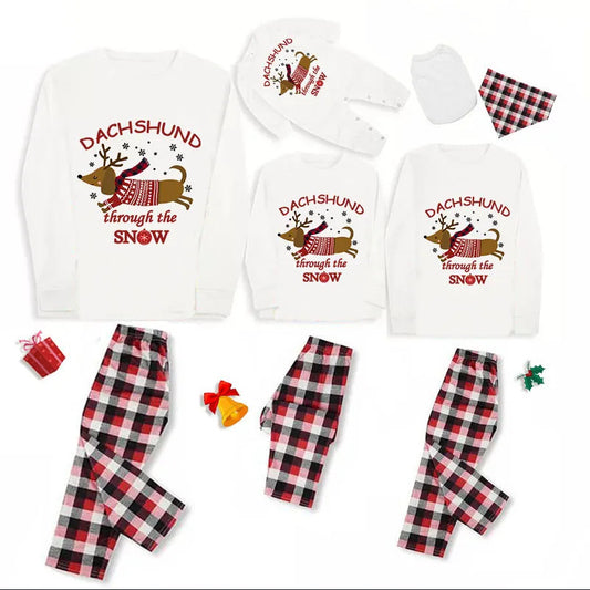 Family matching Christmas pajamas with white long-sleeve tops featuring a 'Dachshund through the snow' graphic and red and black plaid pants. Includes adult, ch