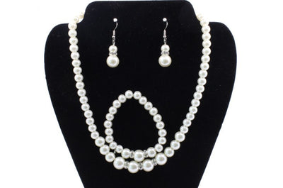 Off-white pearl necklace, matching drop earrings, and bracelet set with rhinestone accents for bridal wear. - Image 5