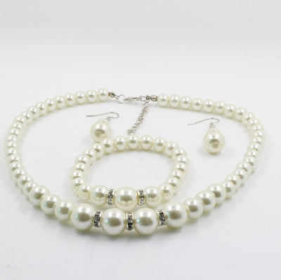 Off-white pearl necklace, matching drop earrings, and bracelet set with rhinestone accents for bridal wear. - Image 2