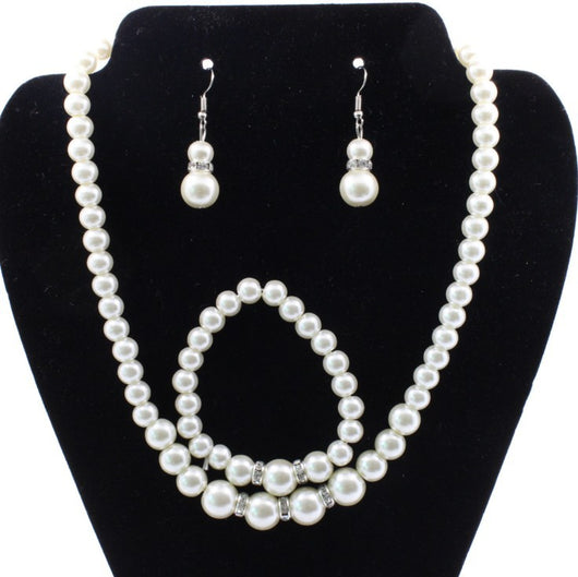 Off-white pearl necklace, matching drop earrings, and bracelet set with rhinestone accents for bridal wear. - Image 3