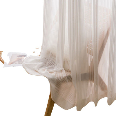 White vertical blinds with a pleated texture, allowing sunlight to filter through and cast shadows on an open magazine. - Image 5