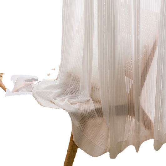 White vertical blinds with a pleated texture, allowing sunlight to filter through and cast shadows on an open magazine. - Image 5