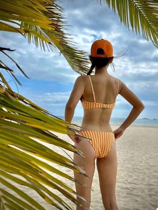 Orange and light orange striped bikini bottom with a ribbed texture and elastic waistband, ideal for beach vacations. - Image 18