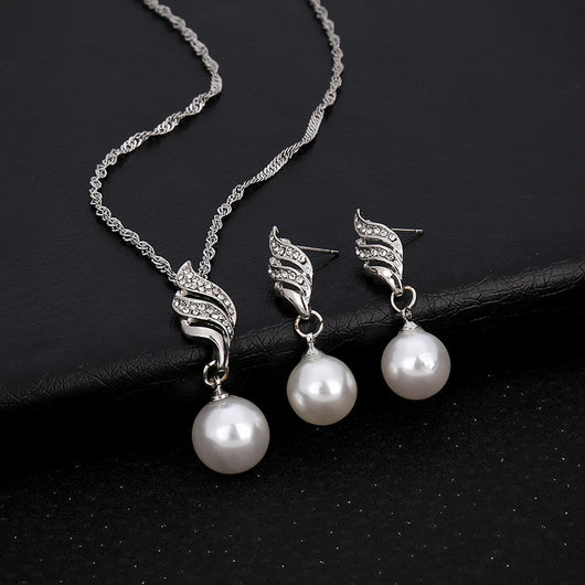 Gold-toned necklace and earring set with white faux pearls and clear rhinestones in a wavy design. - Image 7
